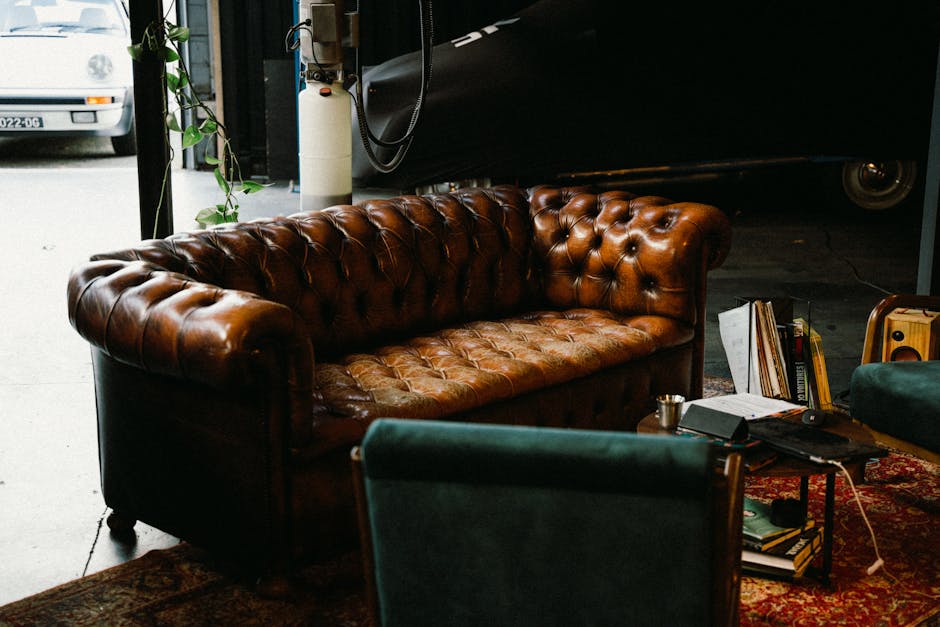 A classic brown leather sofa with vintage decor in a cozy indoor atmosphere.